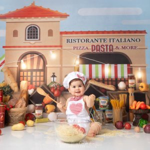 Celine | 20 days | Newborn photography 4 Adorable baby dressed as a little chef playing with spaghetti during a Baby Chef Photoshoot in Sydney at Blossom Brook Studio.