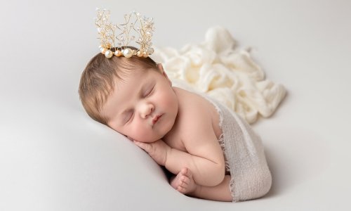 Beautiful newborn baby sleeping peacefully with a delicate crown, captured at Blossom Brook Studio – Newborn Photography Sydney.