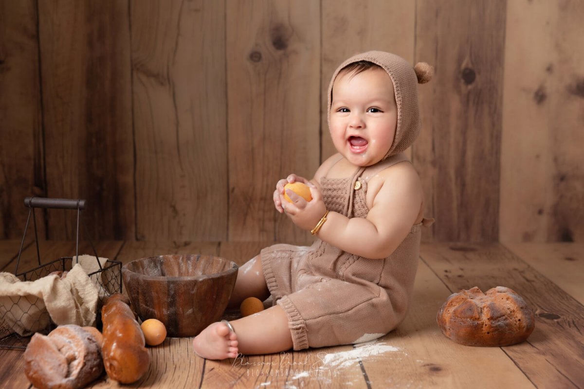 baby photos in sydney baby boy in bear costume on wooden floor