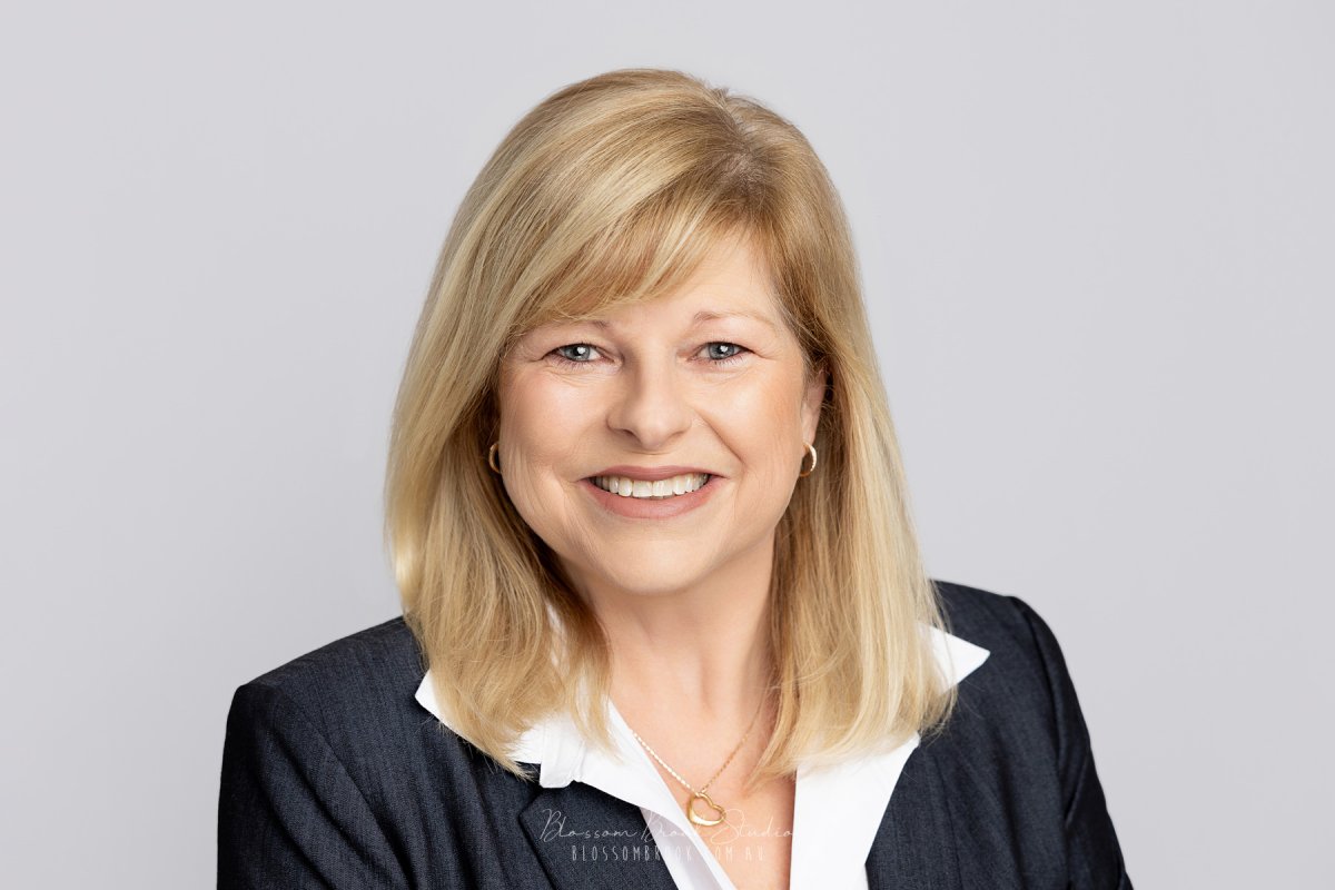 Professional corporate headshots of a smiling blonde woman in business attire on a light gray background.