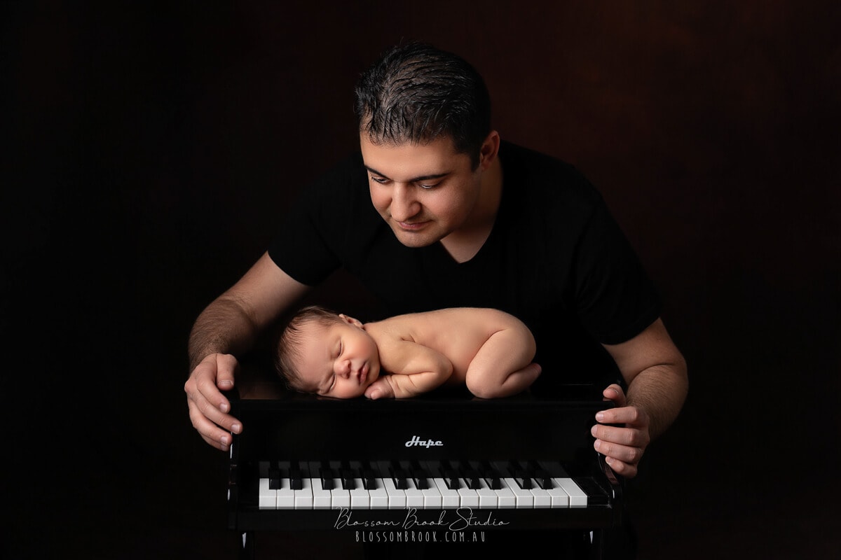 newborn baby photo with piano and dad